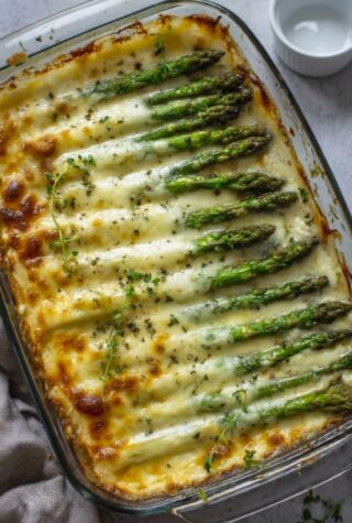 HomeCheesy Baked Asparagus Cheesy Baked Asparagus       This Cheesy Baked Asparagus is the perfect side dish—tender-crisp spears roasted until golden, then blanketed in a light, creamy cheese sauce and baked until bubbly. It’s rich without being heavy, quick enough for weeknights, and fancy enough for holidays.  With just 6 ingredients and one pan, it’s proof that the best sides are often the simplest.        Why You’ll Love This Recipe 🥦 Tender-crisp asparagus with zero soggy stems 🧀 Creamy, cheesy topping that’s not overpowering ⏱️ 10 minutes prep, 10–15 minutes bake 💸 Costs under $6—feeds 4 generously 🌾 Naturally nut-free & easily gluten-free Ingredients You’ll Need (Serves 4)  1½ lbs (680g) fresh asparagus, woody ends snapped off 2 tbsp olive oil Salt & black pepper to taste For the Cheesy Topping: