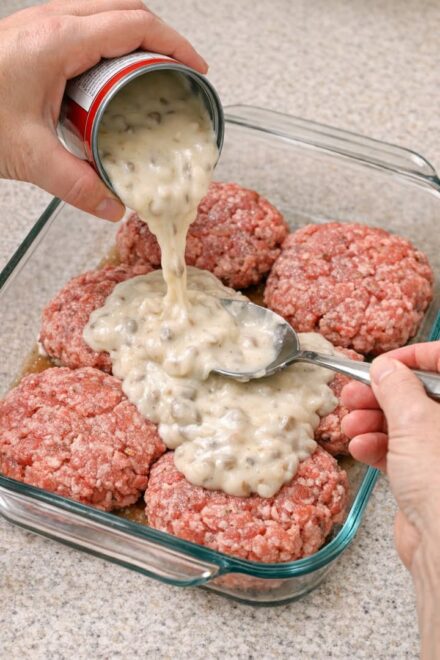 Pour cream of mushroom soup over raw ground beef patties, coupled with 2 ingredients, into a glass baking dish for a hearty supper that’s the one everyone asks for